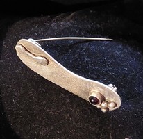 Special silver brooch, badge with garnet stone
