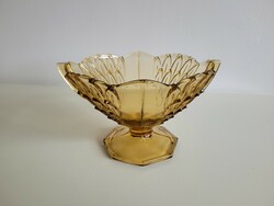Old art deco amber-colored glass bowl with a base, glass bowl in the middle of the table