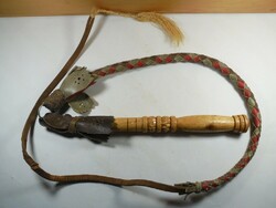Old ringed whip made of leather and wood