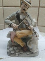 Street musician with dog, figurative porcelain for sale! Fétfi sitting on a bench playing the violin with a dog
