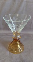 It has a special shape and color. The chalice part of the glass has a polished grape motif!
