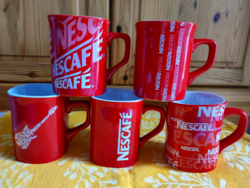 Red coffee mugs with Nescafé inscription