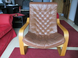 Comfortable armchair with quilted soft leather padding.