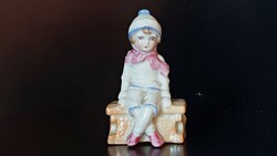 Rare, antique, German, small porcelain. Sitting child in winter clothes. 9 cm high.