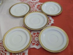 Porcelain tea cup coasters with a beautiful golden border on a snow-white background