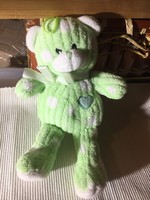 Green teddy bear with hearts