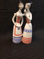 The porcelain figure of Raven House ladies in folk costume is damaged!