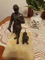 Tin statue of a hunter with his dog