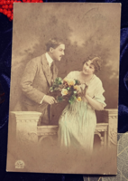 Antique postcard with a couple in love