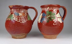 1L841 pair of old brown glazed hand-painted earthenware jugs