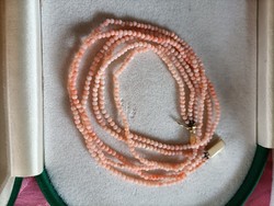 3 Rows of tiny coral pearls with a gold clasp