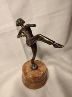 Bronze dancer statue with museum seal at the bottom