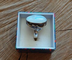 A beautiful silver ring with a rainbow moon and a beautiful blue play