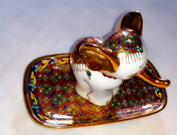 A particularly beautifully painted lucky elephant on a salt shaker tray