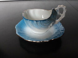Antique fine thin porcelain coffee cup with a shell-shaped coaster