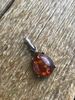 Old silver pendant with amber stone