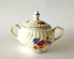 A small granite sugar bowl with a twisted pattern of field flowers and a blue border in its old material