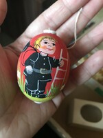 Unique hand-painted red egg with a chimney sweep pattern