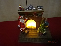 Christmas diorama, illuminated fireplace, with rotating Christmas tree. Jokai.