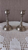 Pair of metal candle holders, marked met, 12 x 7 x 4 cm, inner diameter for candle: 2 cm.