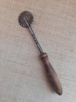 An old, beautiful derecho cutter with a decorative wooden handle