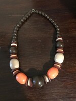 Old, beautiful, colorful, wooden necklace. The orange and brown parts are made of plastic. 52 cm long.