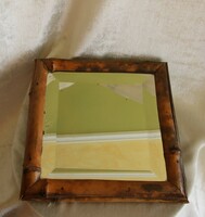 Antique mirror with carved, polished bamboo frame