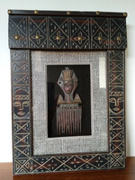 A special African showcase picture with an inlaid metal replica of a tribal comb