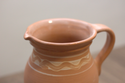 Decorative clay pouring jug