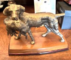 Hunting dog with a rabbit in its mouth - bronze statue on a wooden plinth