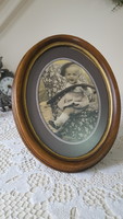 Old oval wooden picture frame with non-reflective glass