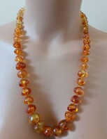 Older imitation amber necklace with growing eyes