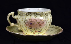Around 1900 A hand-painted porcelain tea cup with a neo-rococo pattern