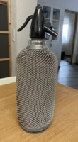 Old mesh soda bottle with soda siphon glass container