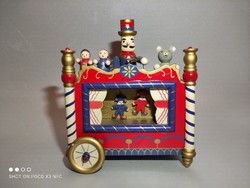 A wooden musical antique-effect traveling puppet theater with moving figures that matches the Christmas atmosphere