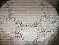 A special fairy-tale hand-crocheted antique oval white tablecloth with embroidered art nouveau features