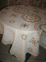 Beautiful antique hand-embroidered woven tablecloth with lace on the edge
