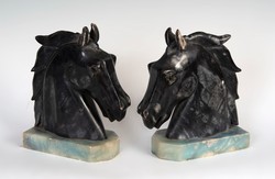 A pair of art deco style marble bookends in the shape of a horse's head