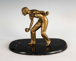 Statue of a bowling man on a marble base