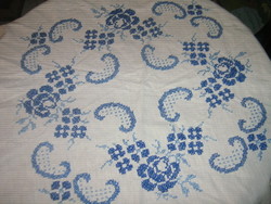 A beautiful cross-stitch blue rose pattern round tablecloth with a slinged edge