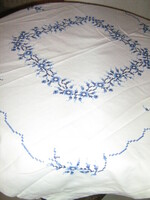 Beautiful hand-embroidered white tablecloth with a blue motif