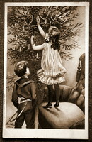 Antik Karácsonyi üdvözlő grafikus képeslap kisleány fotelen állva karácsonyfát díszít