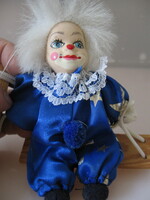 Seated clown with a retro porcelain head