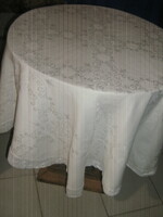 Beautiful round white silk damask tablecloth with a baroque pattern with a lace edge