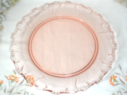 Coral-colored round glass cake plate, offering