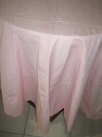 A beautiful pink oval tablecloth with a slinged edge