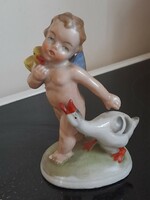Charming old porcelain figurine of a boy with a goose