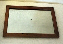 Old small mirror with a wooden frame