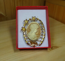 Handmade cameo brooch. Precisely worked golden color with a silky shine. Gold number. Beautiful case.