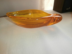 A thick glass fish-shaped ashtray or tray